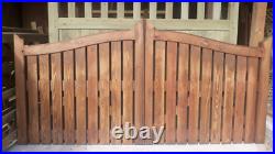 A pair of low driveway wooden gates with curved top in hit & miss style 8' wide